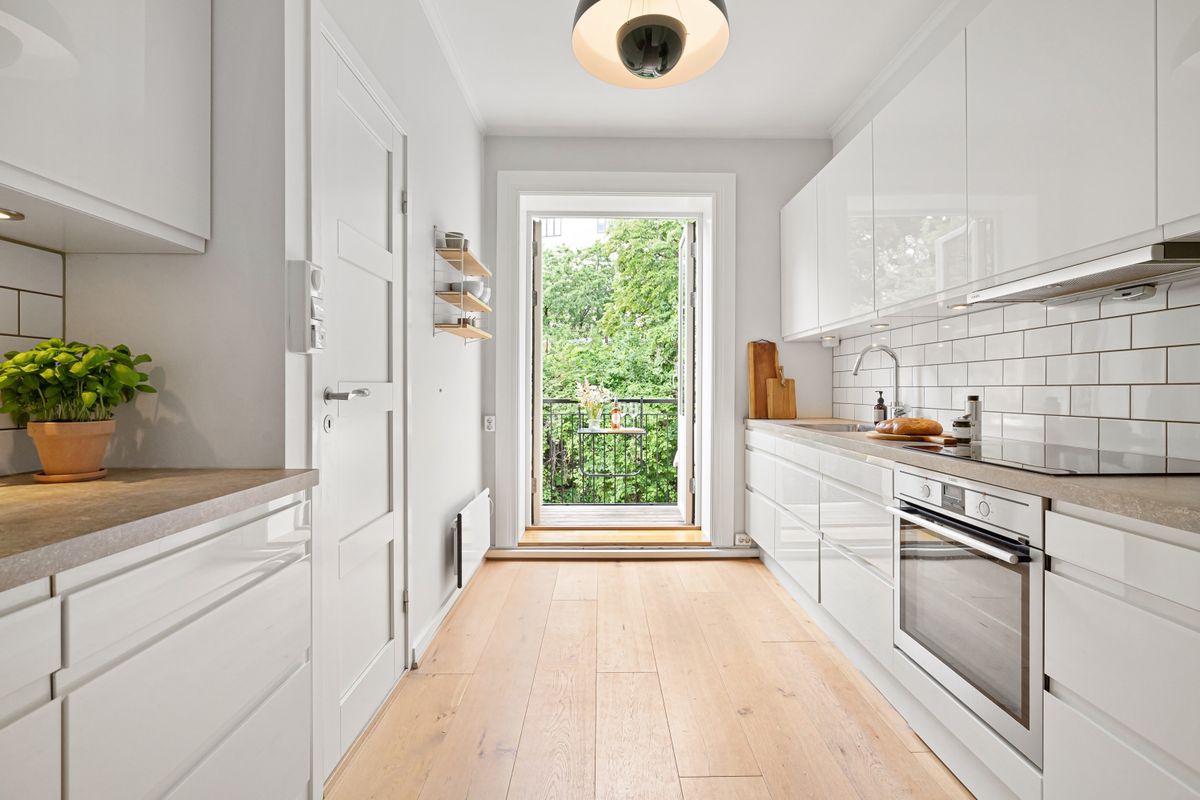 Compact modern white kitchen with a small balcony